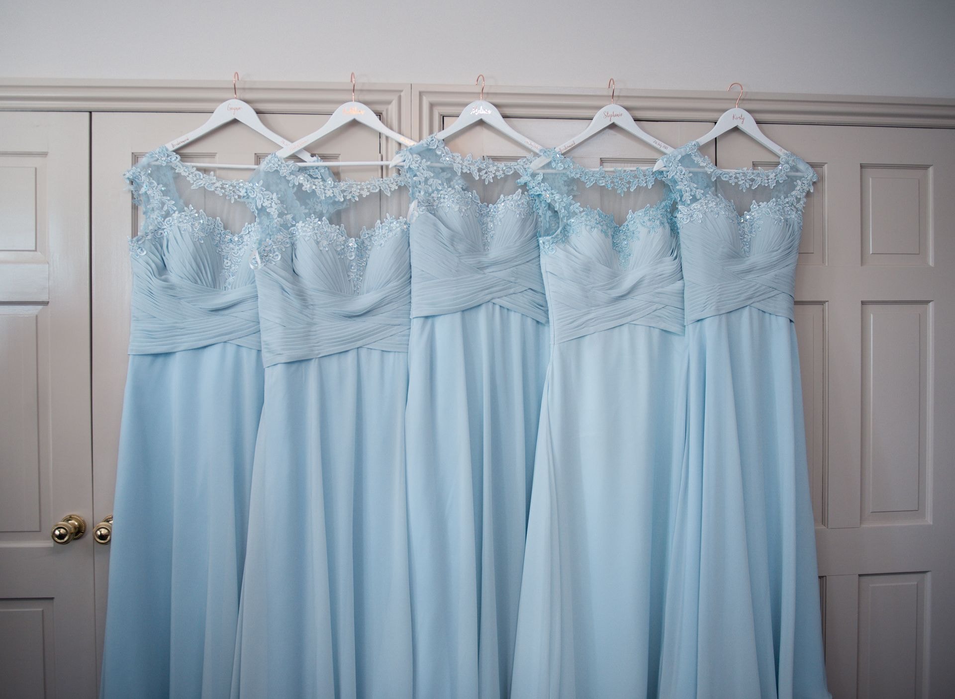 Light-blue bridesmaid dresses hanging on display