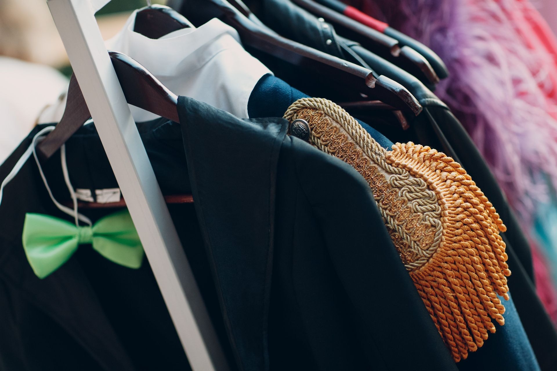 Costume garments and designer dresses displayed on hangers