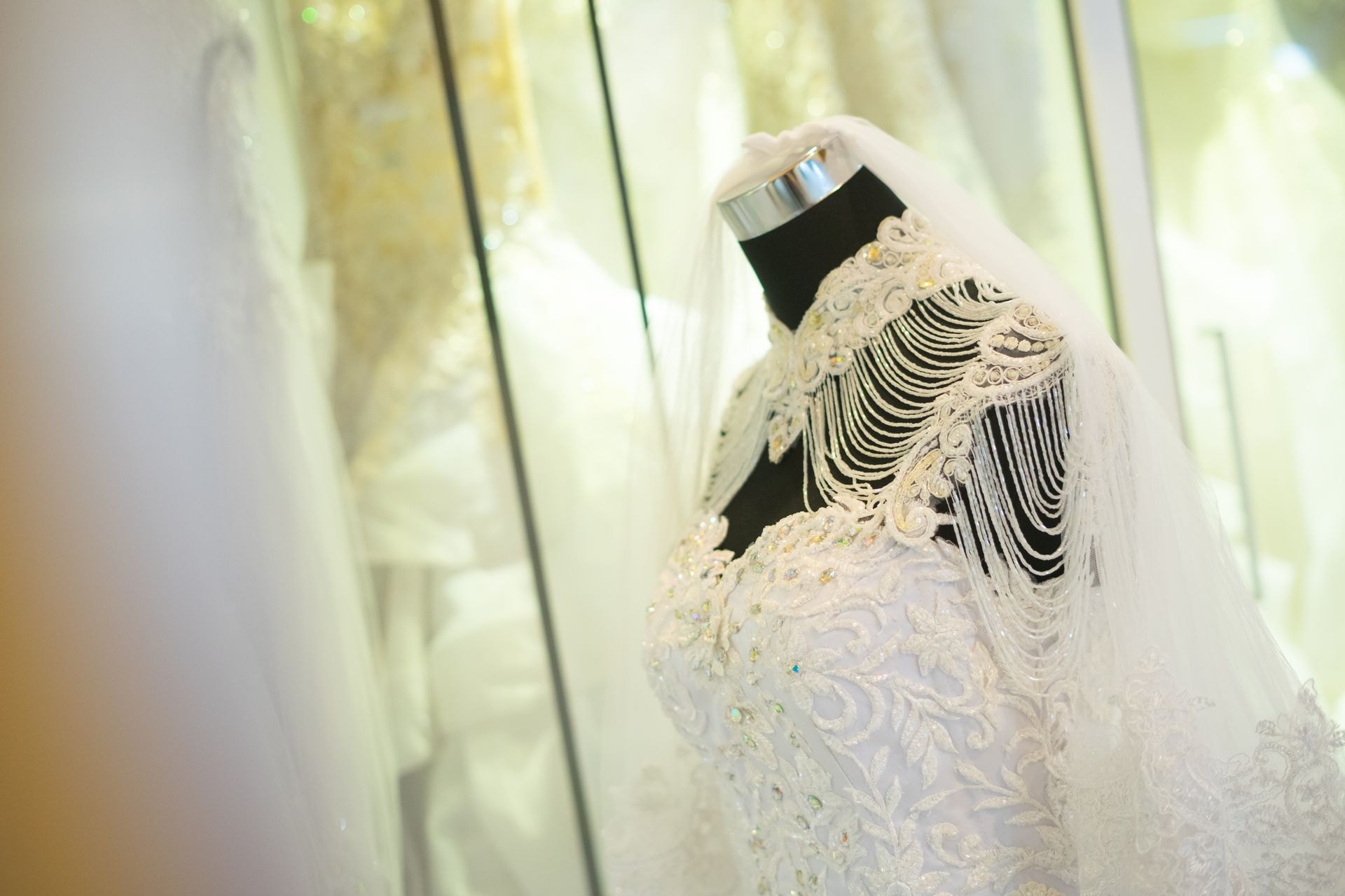 Tailor sewing white bridal fabric at a sewing machine