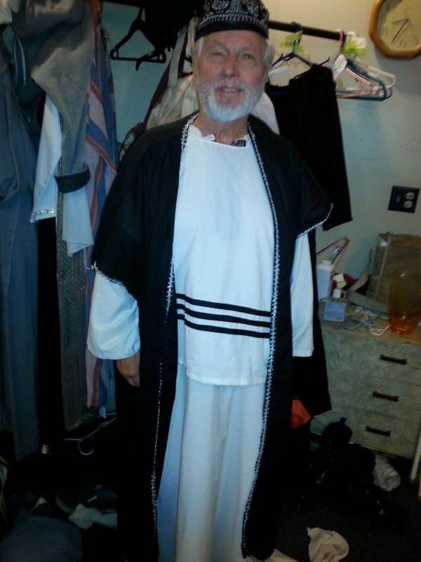 Man wearing religious ceremonial robes indoors